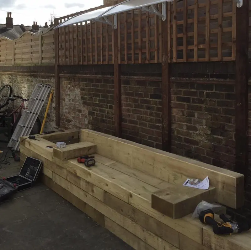 Timber seating area and raised planter under construction for a local charity