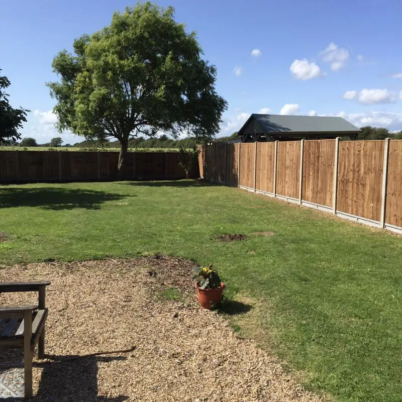 Close board fencing on concrete posts around a garden